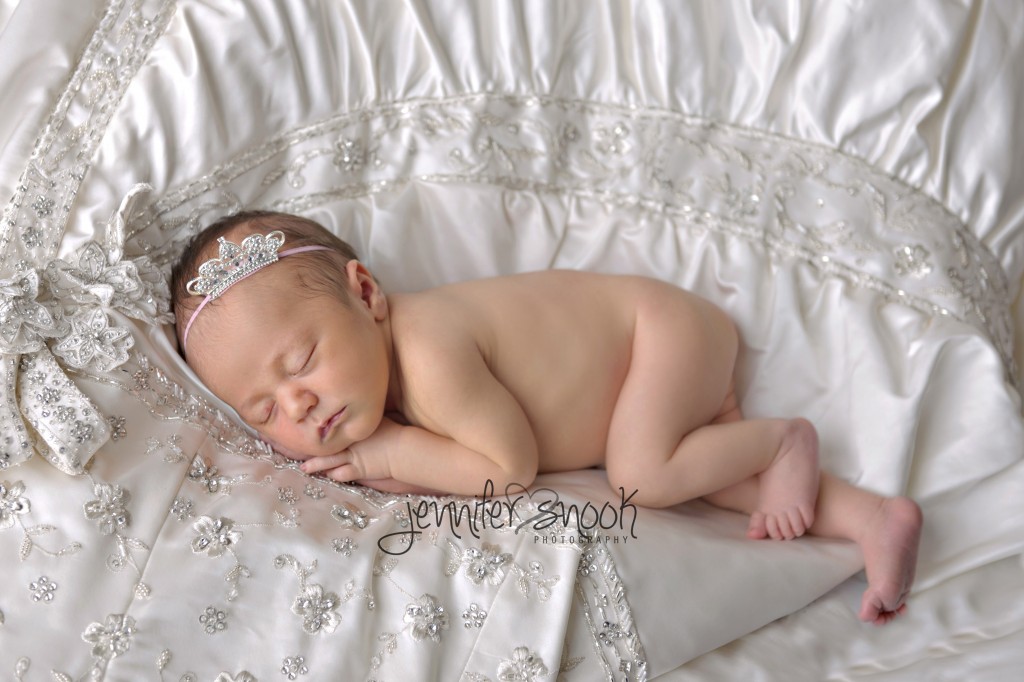 Newborn baby on wedding dress