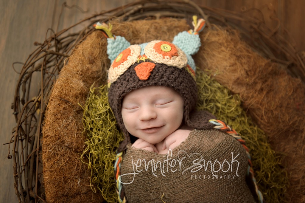 newborn in owl hat and nest